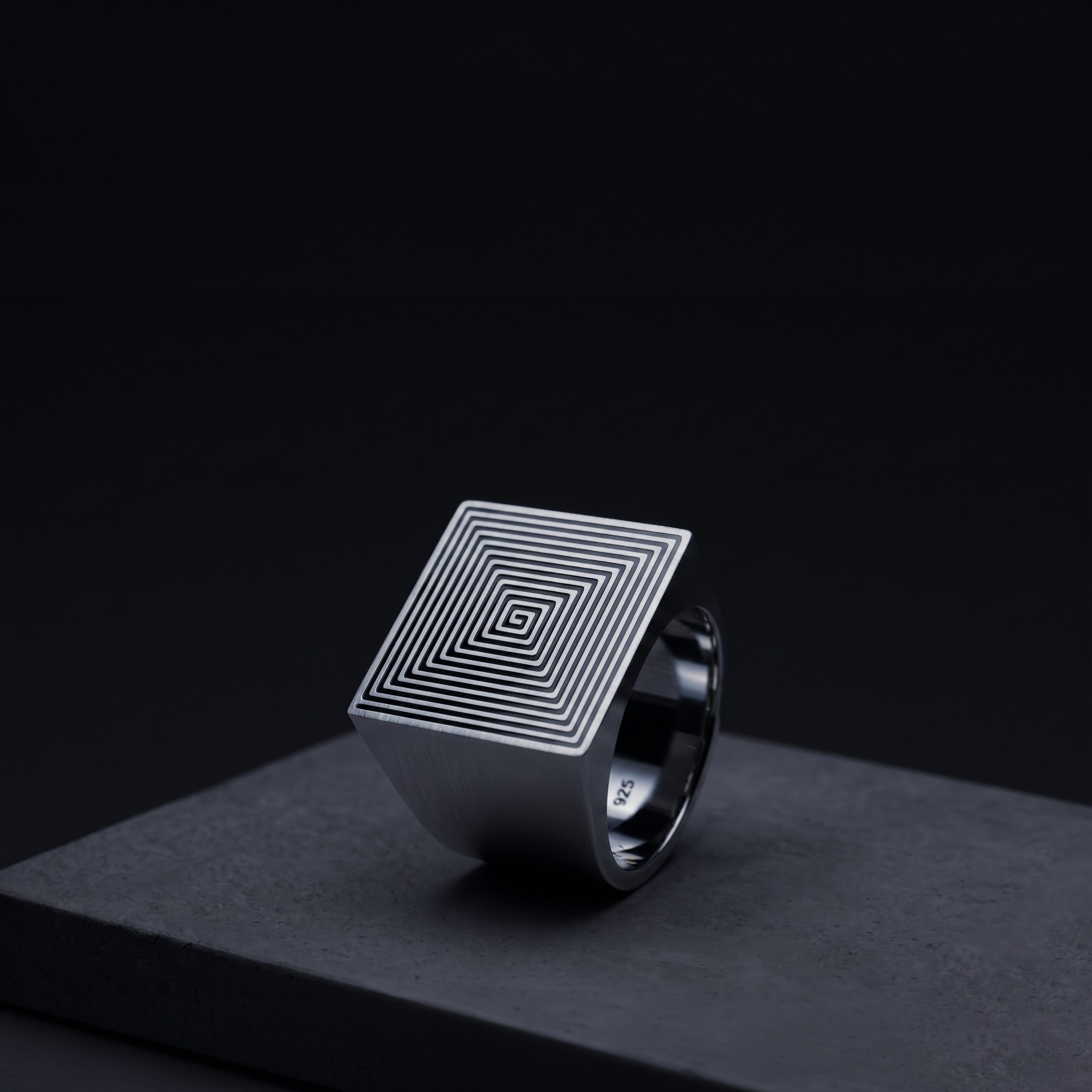 The Signet, Edition 01 — a solid sterling silver signet ring with a square-spiral NFC antenna engraved on its face, housing a battery-free, non-extractable secure element.